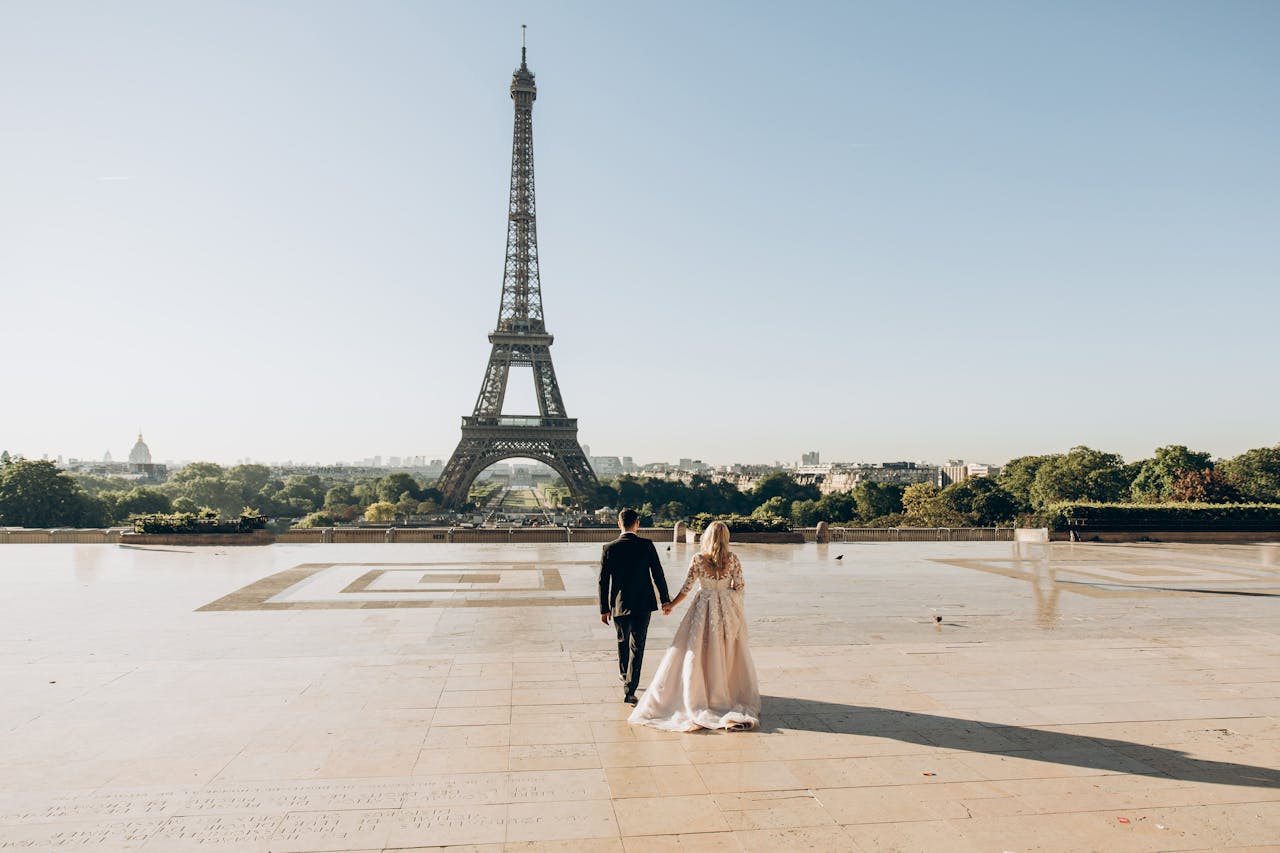 why-choose-us A bride and groom sharing a romantic moment in front of the iconic Eiffel Tower in Paris.
