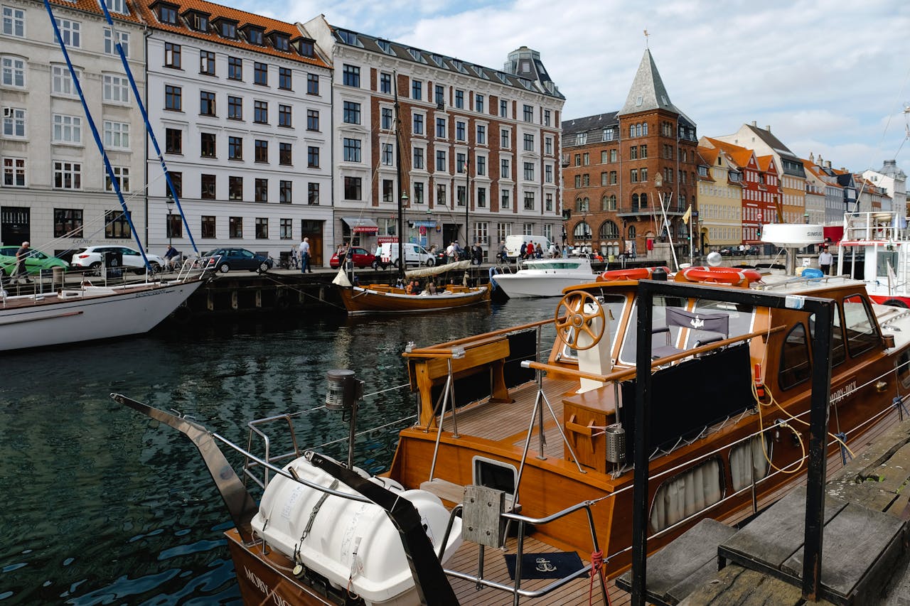 gallery-3 Explore the vibrant waterfront of Nyhavn Canal with historic buildings and moored boats.